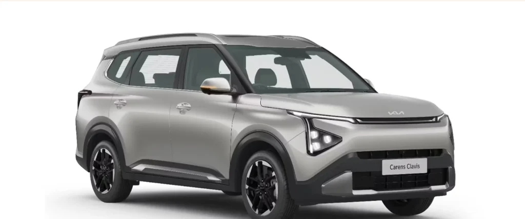 Kia Carens Clavis 2025 silver color front three-quarter view showing sleek LED headlights and alloy wheels